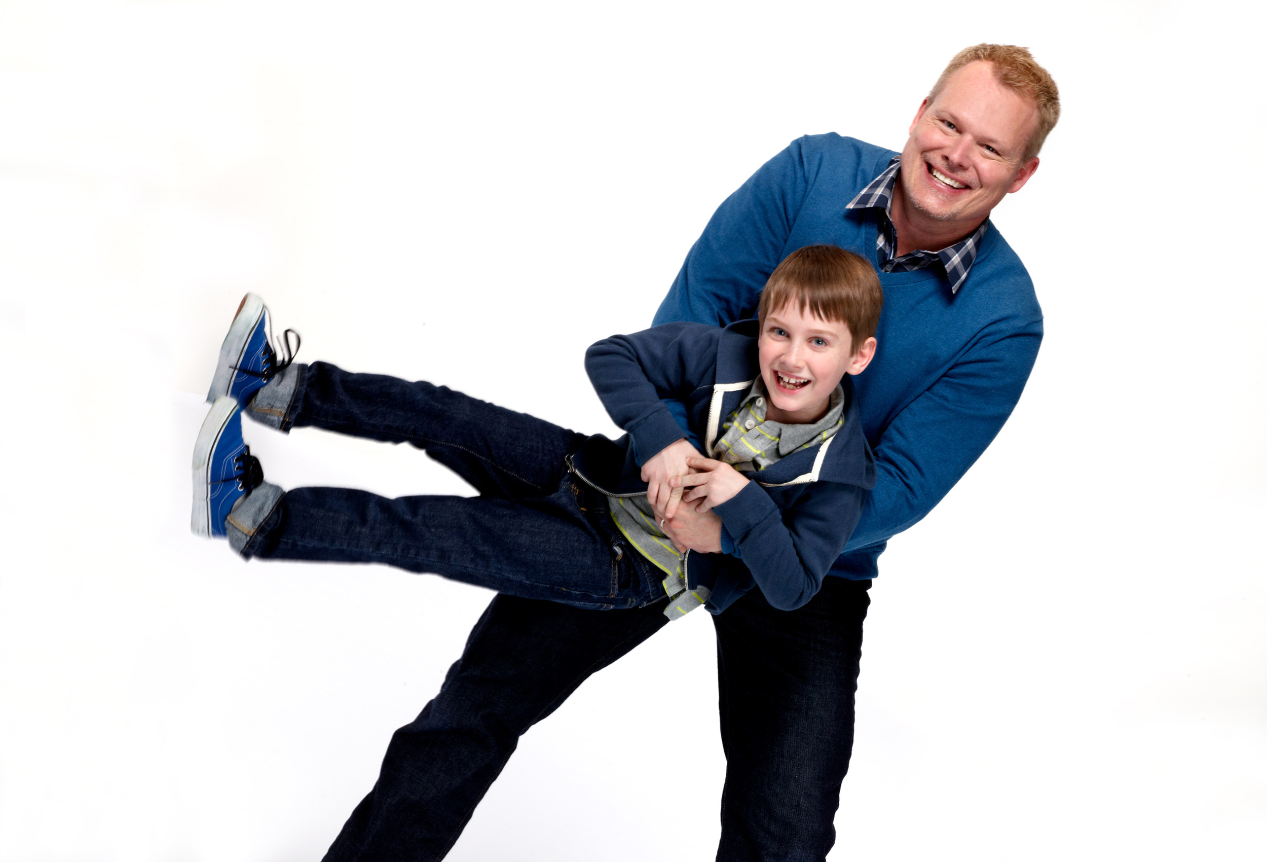 Father and son play on white background for Dr. Scholl