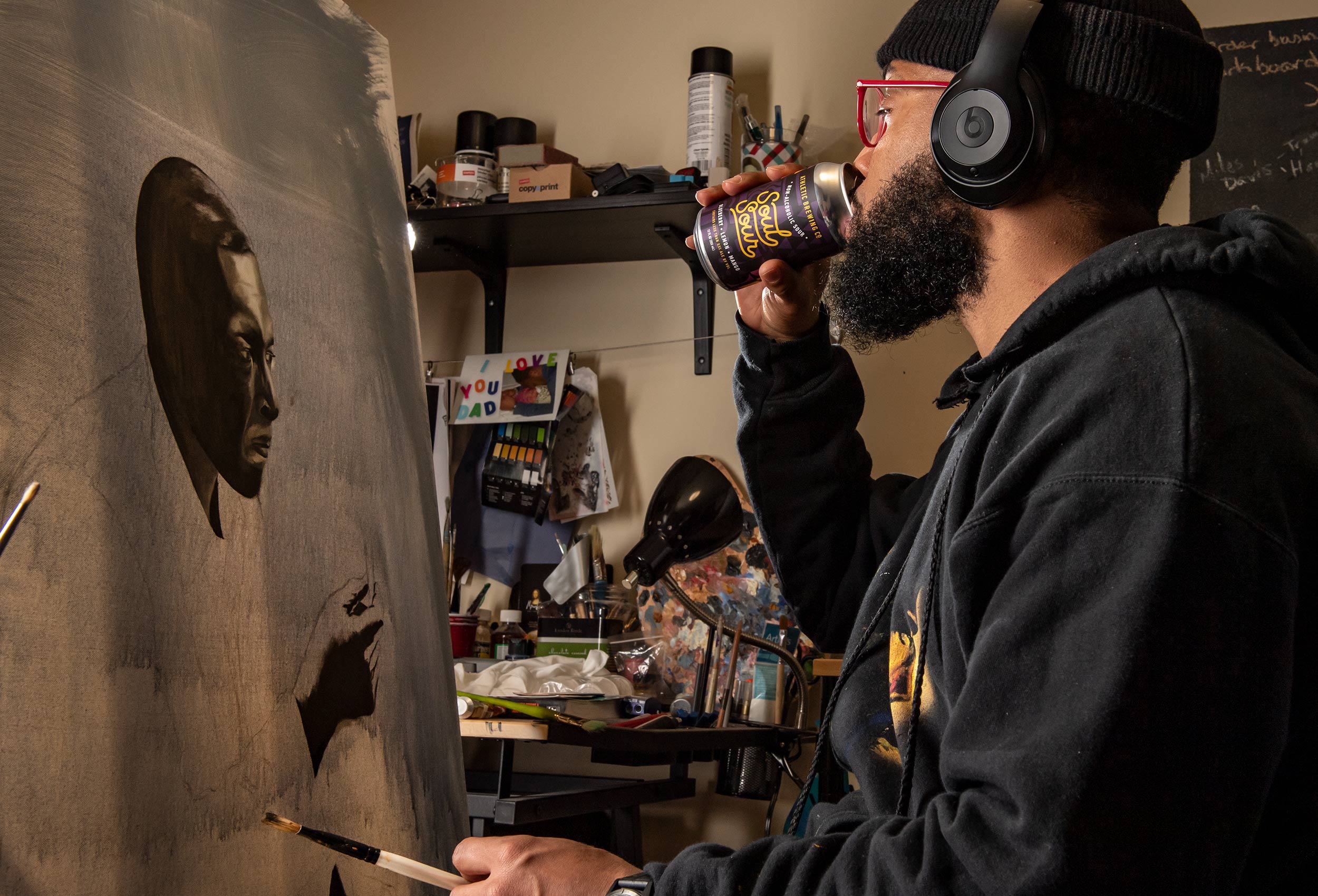 Artist Anthony Cooper-Jenkins drinks Soul Sour non-alcoholic beer while painting in his studiio
