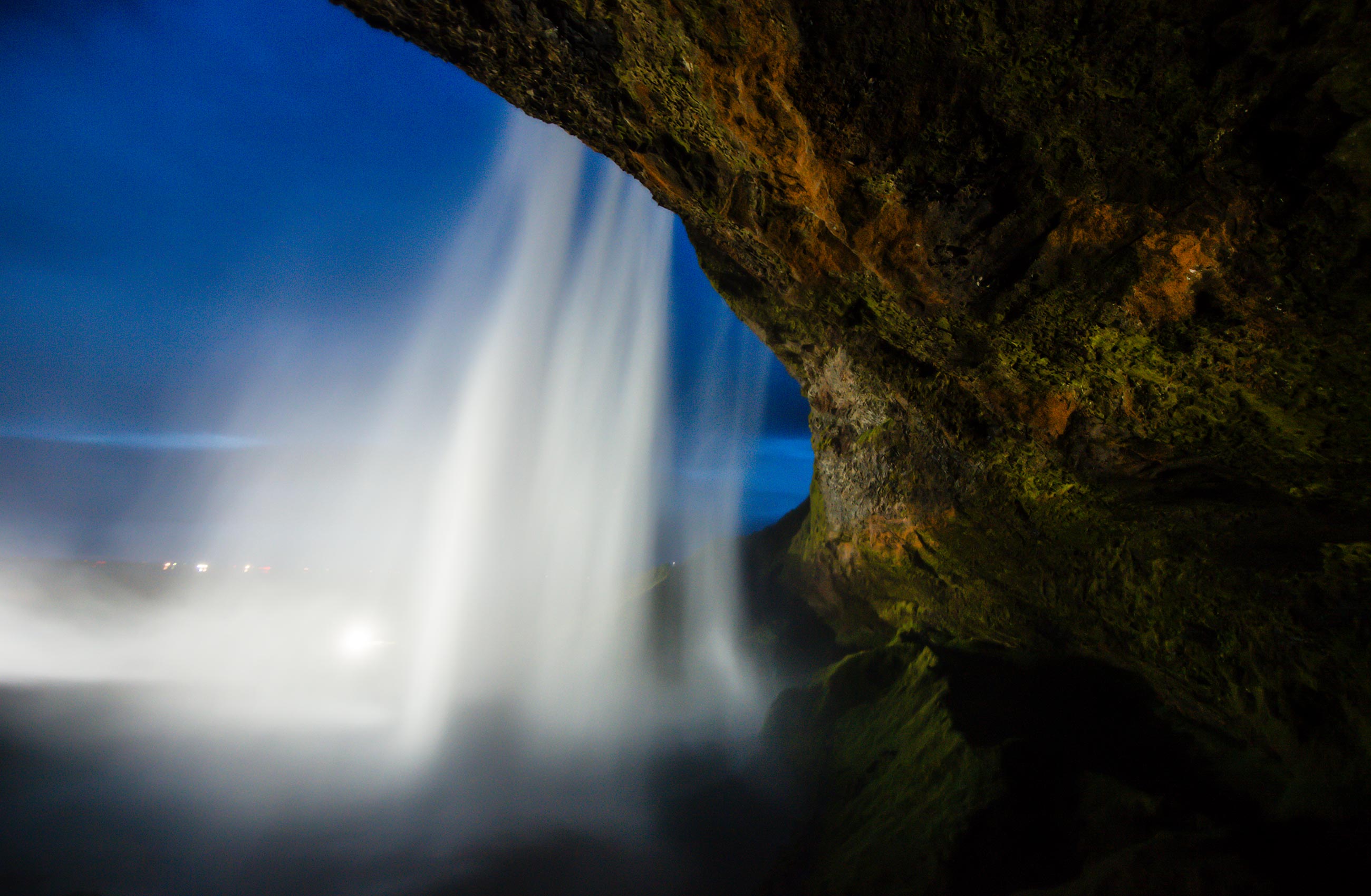 Long exposure photography behind the Skogafoss Waterfall in Iceland at dusk
