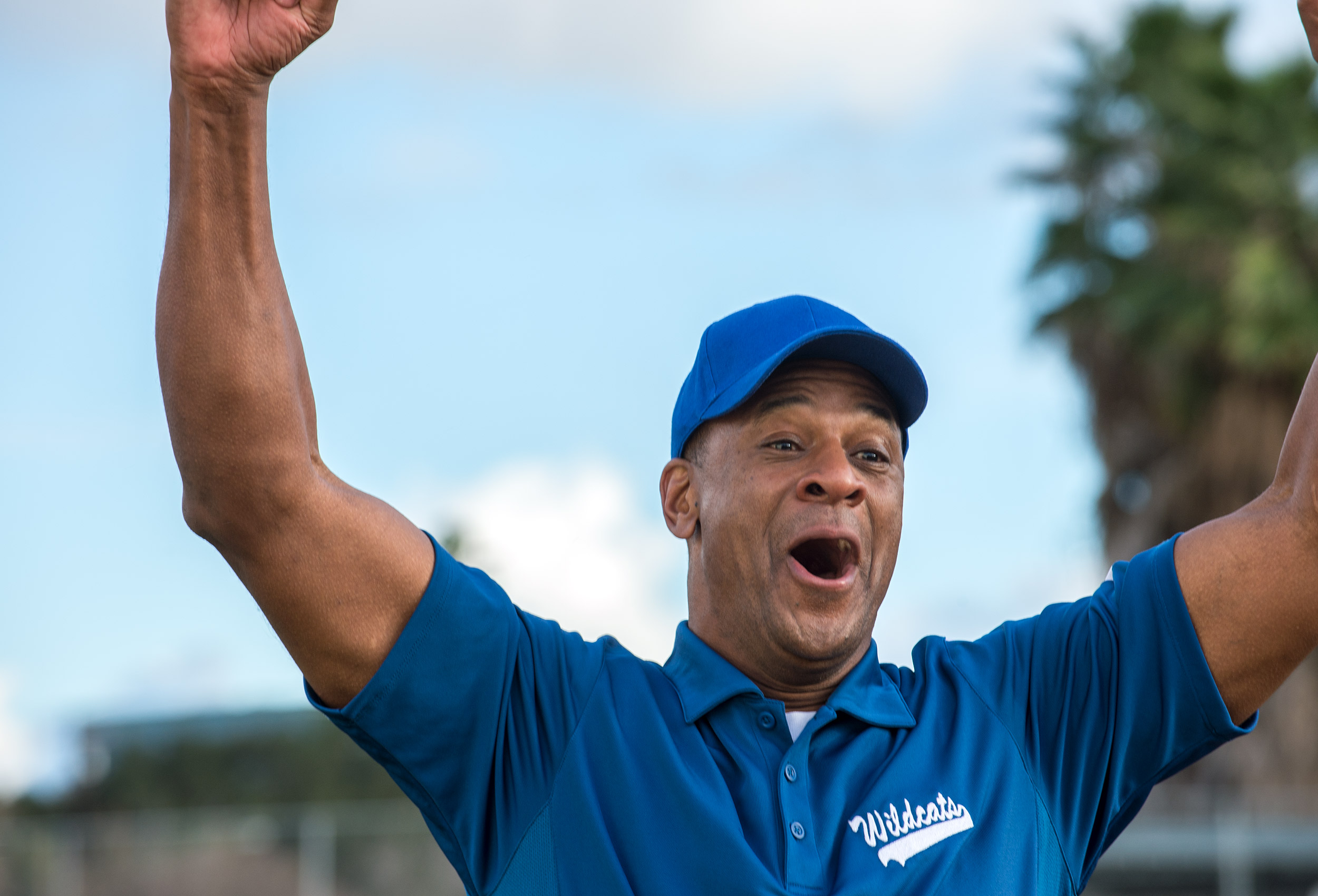 Soft ball coach cheers by NY lifestyle advertising photographer Kathy Cacicedo for Claritin D campaign