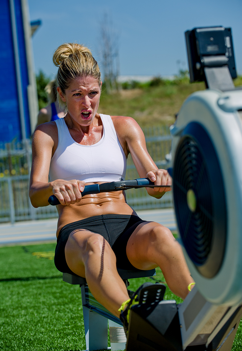 Coppertone Sport Pro athlete Angie Green works out on rowing machine on football field