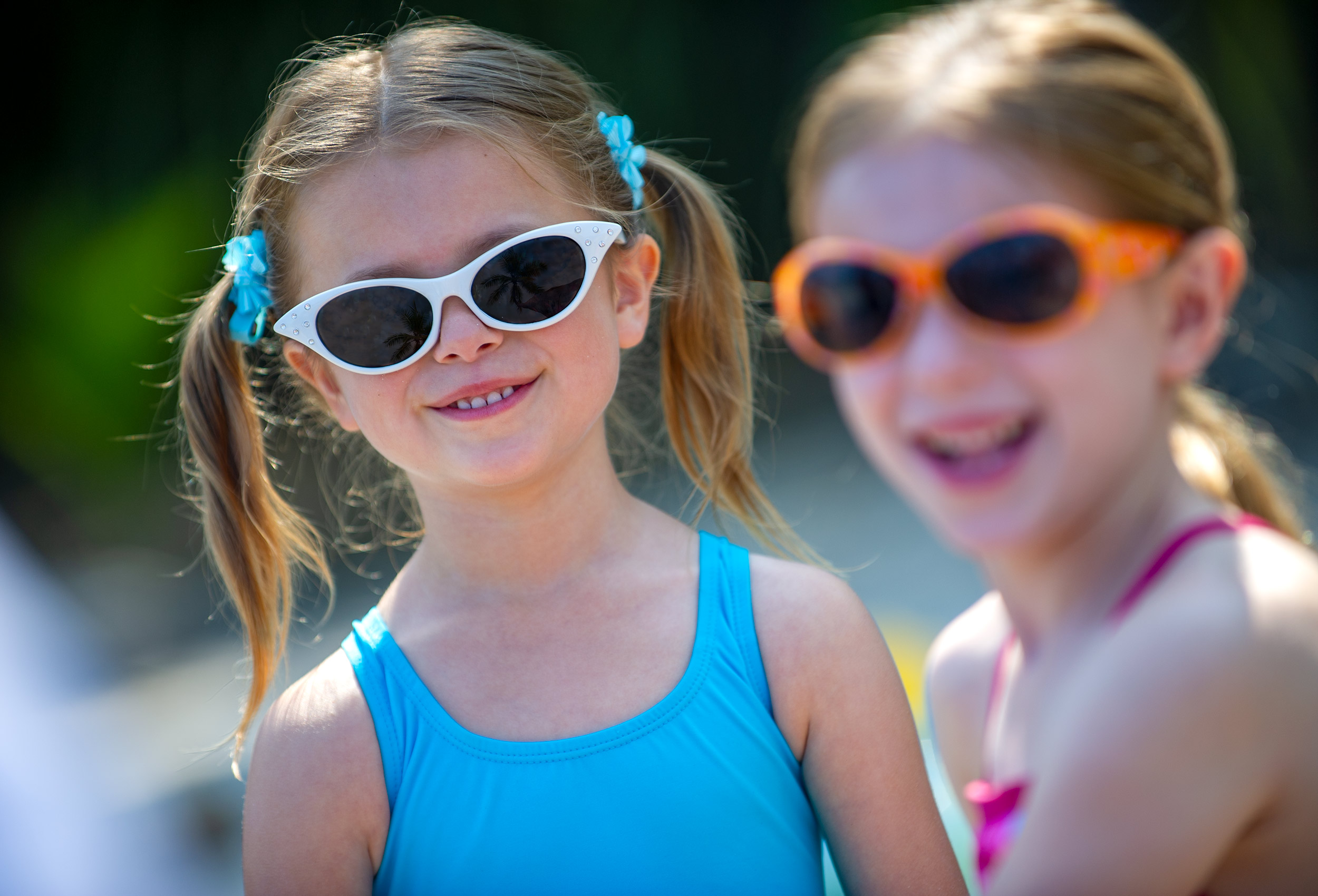 Little girls wearing sunglasses on beach for Coppertone advertising