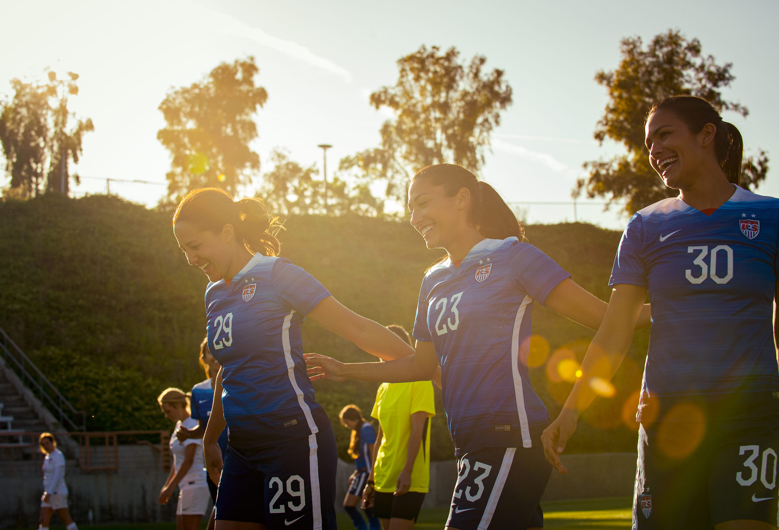 Christen Press soccer star walks with teammates in sun flare for Coppertone Sport