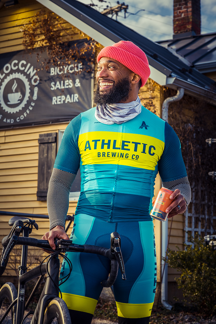Cyclist Anthony Cooper-Jenkins  with Free Wave non-alcoholic beer at Veloccino Bike and Coffee shop Butler MD