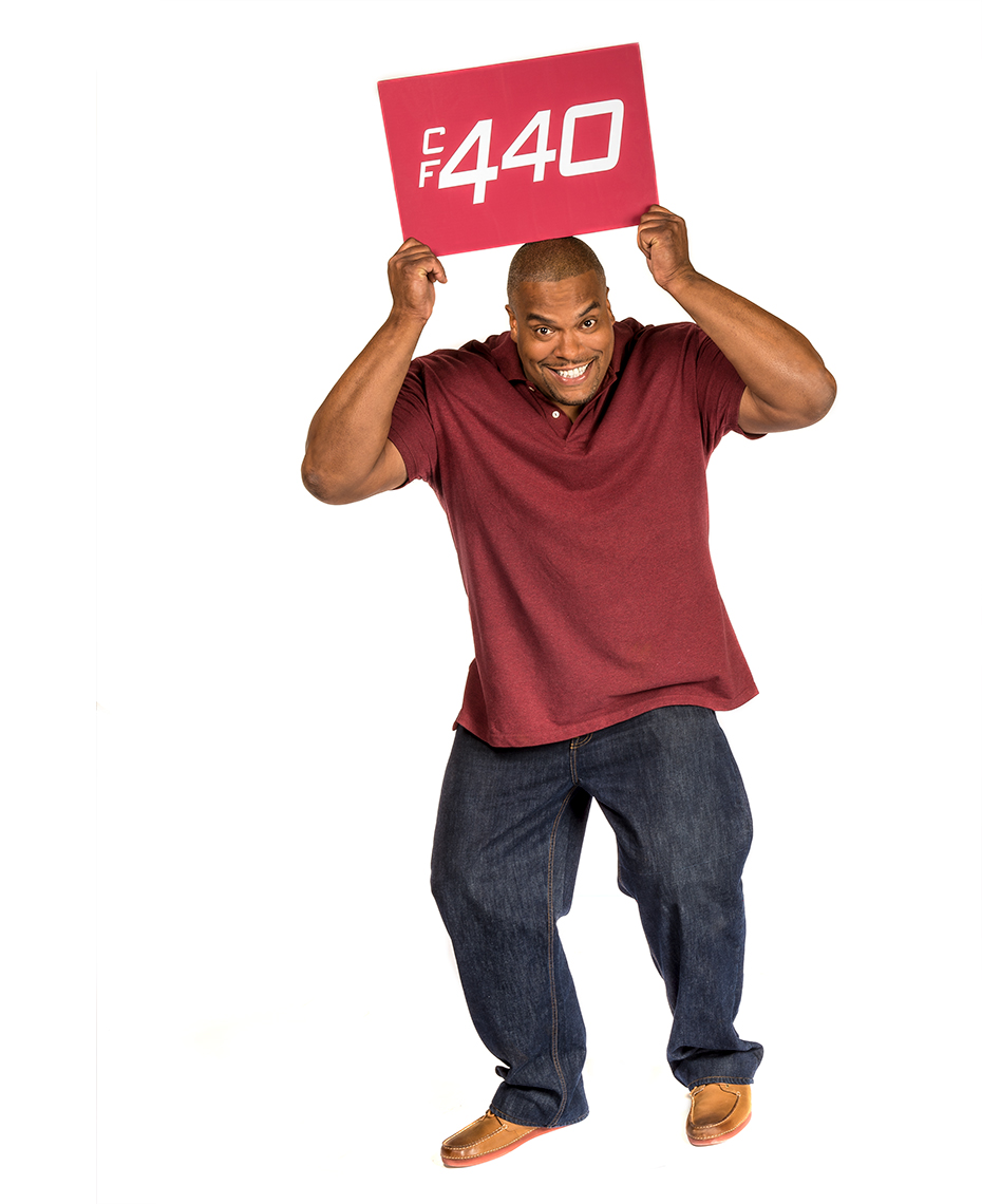 Model holds 440 sign over his head for Dr. Scholls Custom Fit Orthotics advertising campaign