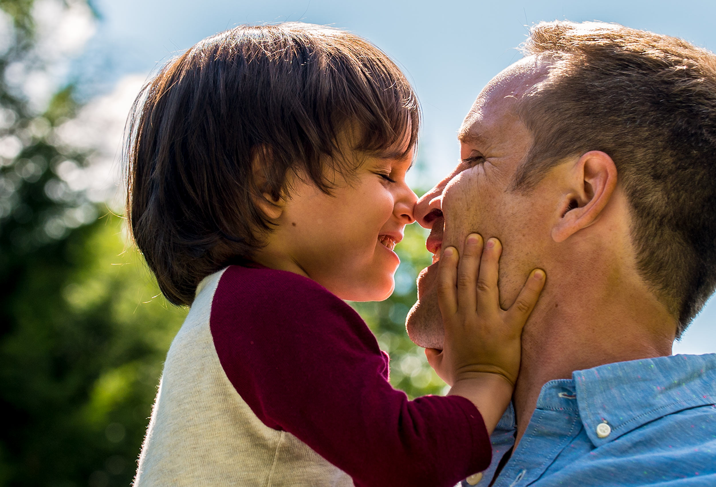 Father and son press noses together - advertising photography for Happy Family Organics
