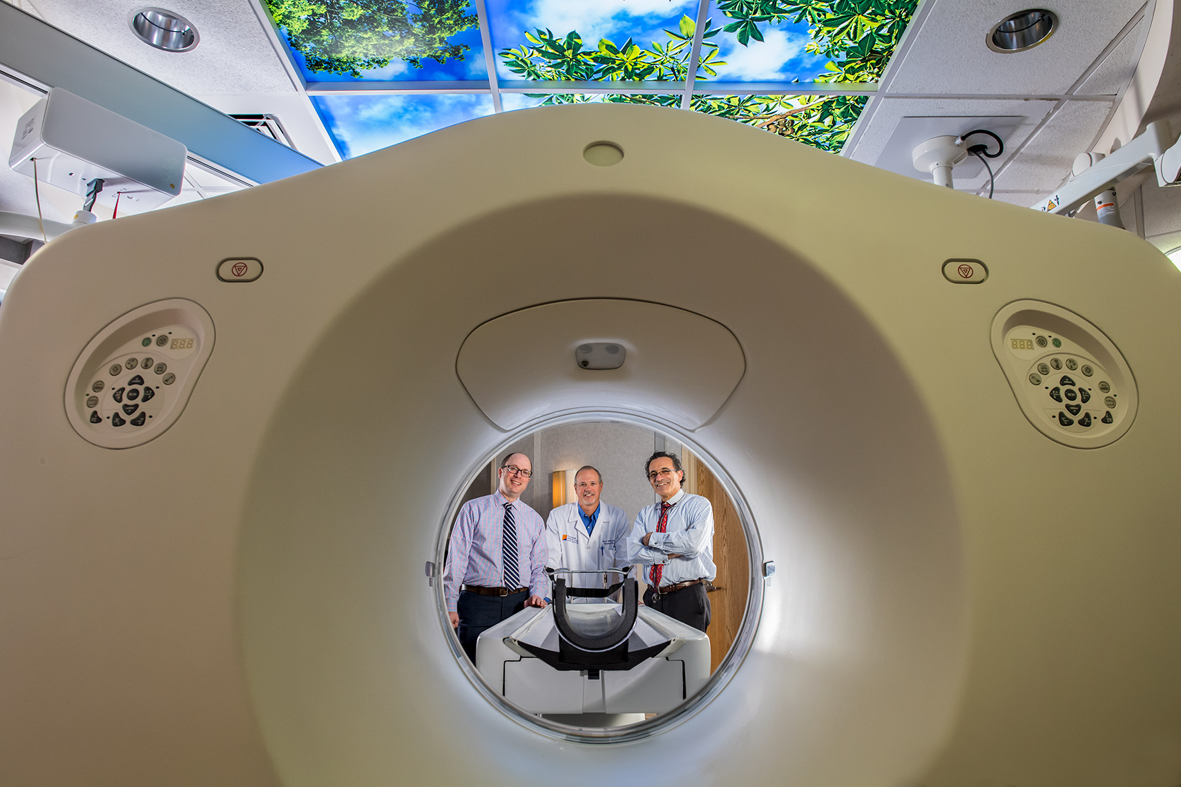 Three doctors portrait with MRI machine
