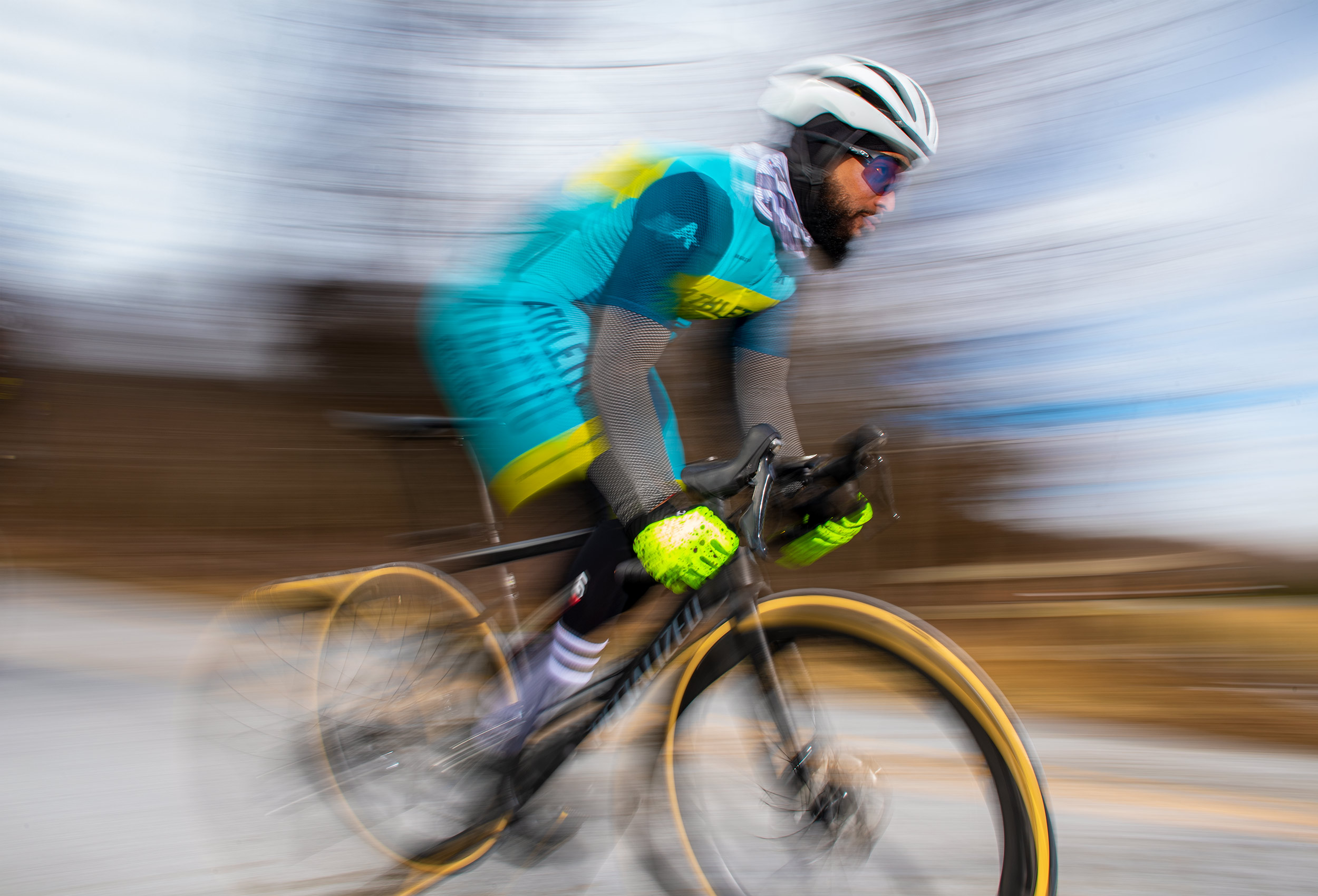 Cyclist Anthony Cooper-Jenkins wearing Athletic Brewing Co. cycle kit - flash blur photography