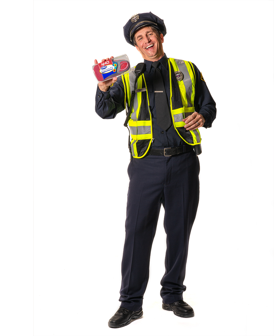 Policeman on white background for Dr. Scholls Custom Fit Orthotics campaign